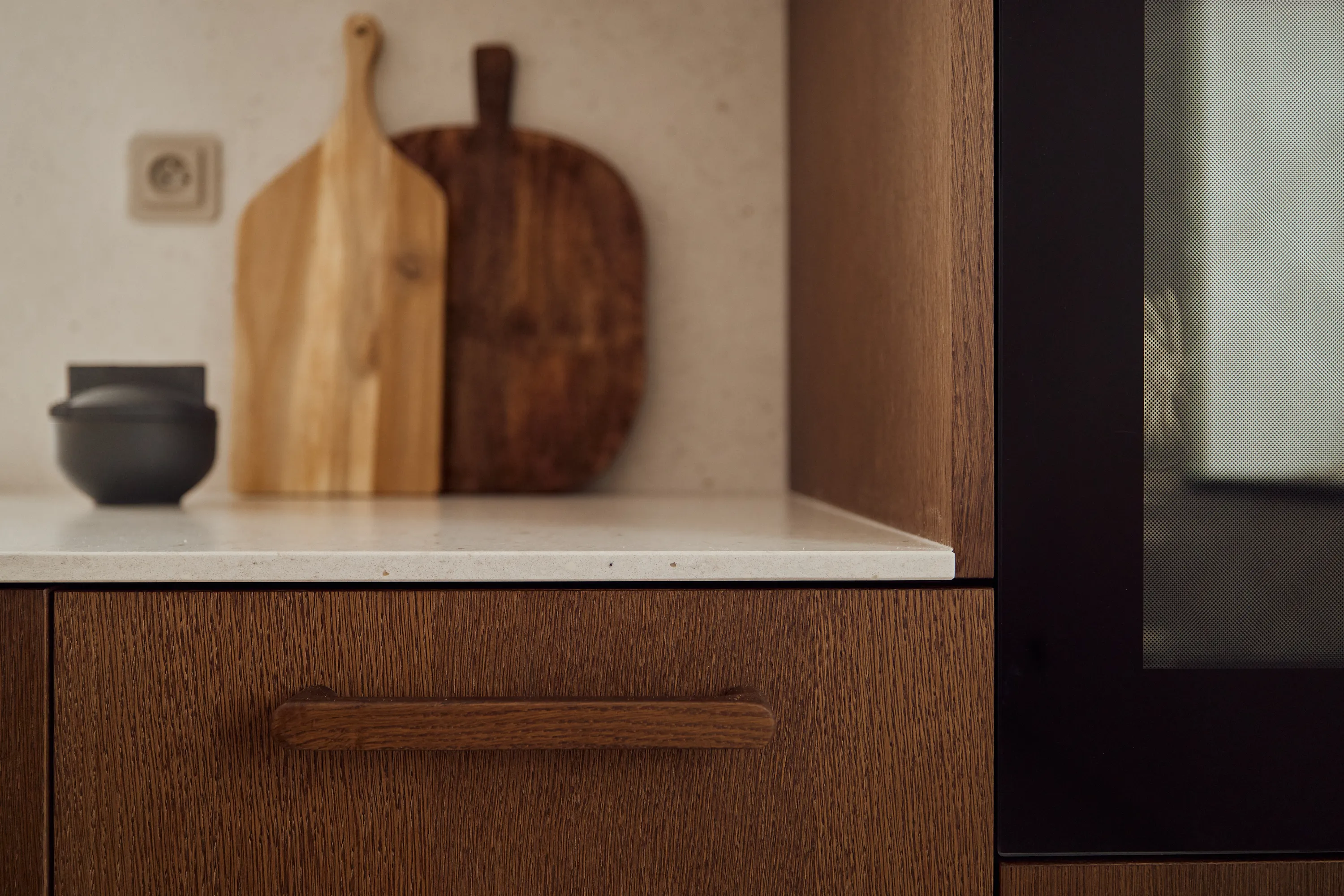Brown oak cabinetry detail with hand-selected hardware and refined profiles